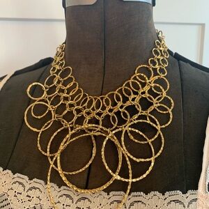 Gold tone hoop and more hoop necklace.